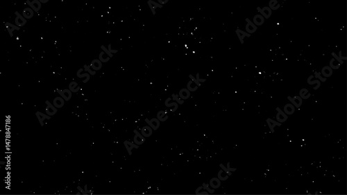 Real falling snow on a black background for use as a texture layer in a photo design. Snowstorm on a black background. 