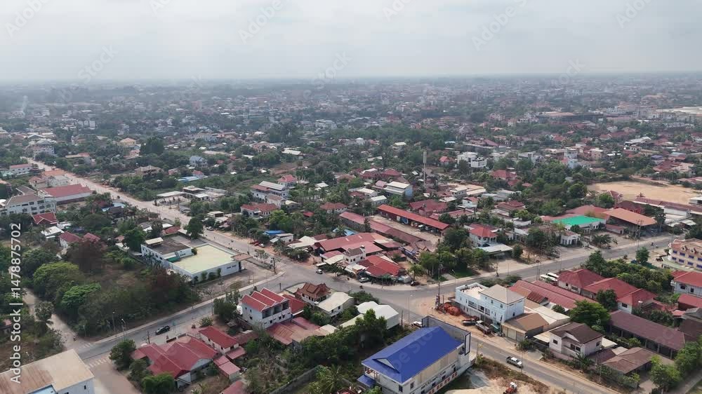 Aerial view of Siem Reap. A main road intersection with less traffic. city's layout is a mix of organised streets. Buildings are Hotel and Resorts for tourists who visits angkor wat Aerial view of Siem Reap. A main road intersection with less traffic. city's layout is a mix of organised streets. Buildings are Hotel and Resorts for tourists who visits angkor wat