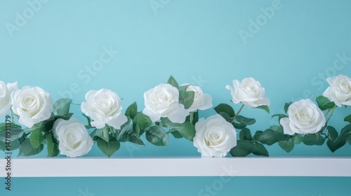 Fototapeta Naklejka Na Ścianę i Meble -  White roses arranged on a shelf against a light blue wall.