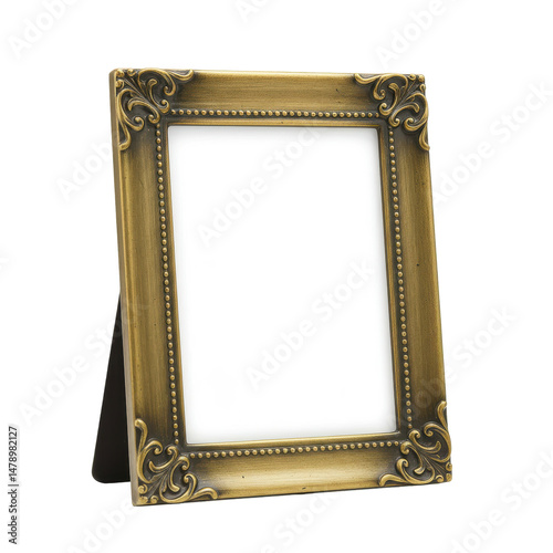 Ornate, empty gold frame with delicate scroll details, standing on a black easel, against black backdrop