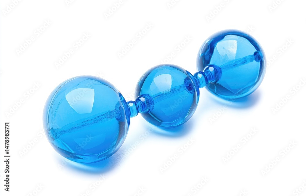 Fototapeta premium Three translucent, vibrant blue, spherical beads connected by a clear rod