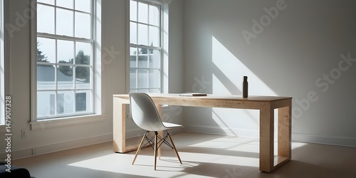 A bright and airy home office with large windows, featuring a standing desk made of birch wood and a white chair. Decorated with a notebook and a water bottle, bathed in strong daylight. 
