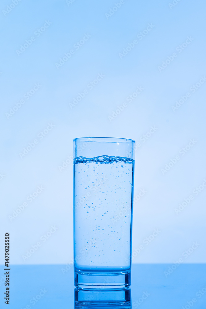 glass of water on blue background