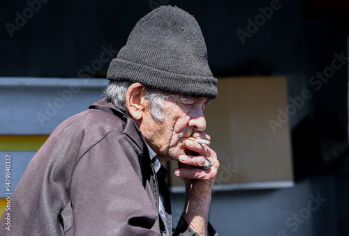 Elderly Russian village man lost in thought, smoking a cigarette in solitude, reflecting on life with a melancholic, distant gaze
