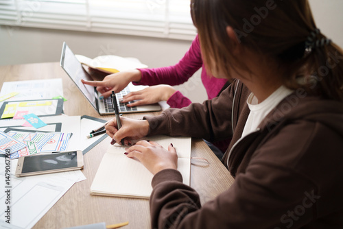 UI UX Designer Teamwork Brainstorming App Interface on Laptop with Asian Women for Mobile Design & User Experience Ideas