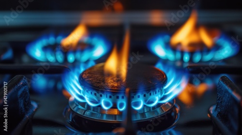 Close-up of a Lit Gas Stove with Vibrant Blue and Orange Flames for Cooking and Heating