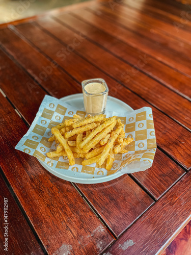 Obraz na plátně A delightful serving of French fries in a quaint basket, showcasing a perfect accompaniment for any meal setting