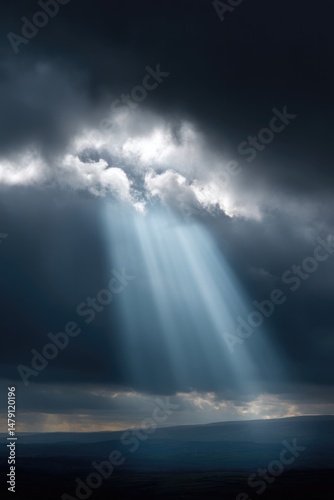 Dramatic rays of light break through dark clouds, creating heave