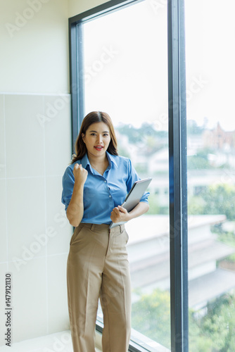 Free Download Attractive asian woman, Manager with laptop stands in office area of coworking space
 - GFXLoad