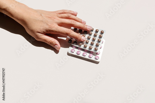 Woman Hand Selecting Contraception Pill Blister Pack. Medical Concept for Reproductive Health and Family Planning.