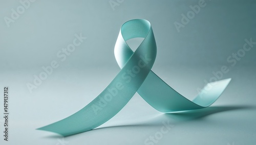 Teal ribbon on light blue background symbol of awareness and support