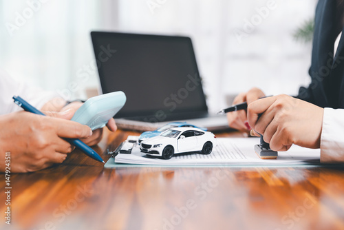 ฺBusinessman approval stamper stamp on paper business contract. car loan money approved. Dealer or manager gives car to customer sign car purchase document with insurance, contract to buy car legal.
