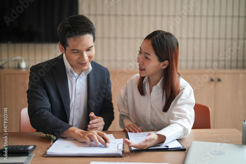 Asian office employee supervising Mentor training trainee at office
