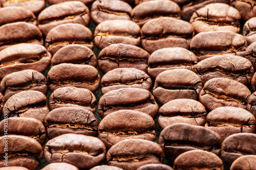 Background of roasted coffee beans. Top view, close-up.