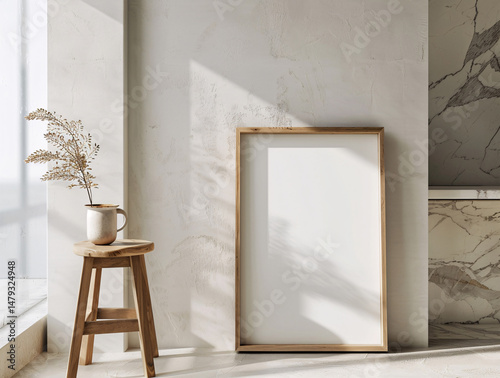 vertical picture frame mockup poster leaning against a light grey wall with plant decor