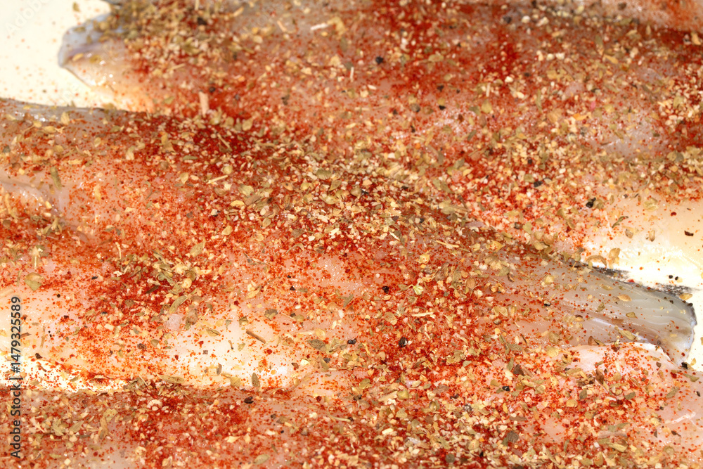Fototapeta premium Close up of seasoned and herb fish waiting to be cooked