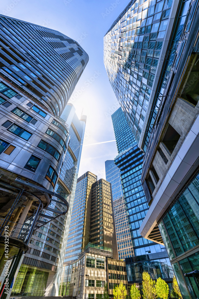 Fototapeta premium Low angle view of the modern office skyscrapers at the City of Frankfurt am Main, Germany, with reflections on the glass facades