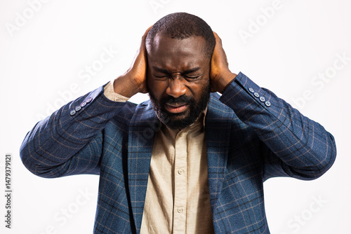 Portrait of tired and exhausted businessman. Black man in business suit is overworked.
