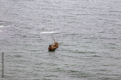 View from Cape Ostry on Sakhalin. A barge at anchor. The coast of the Sea of ​​Okhotsk. Sakhalin, Russia photo