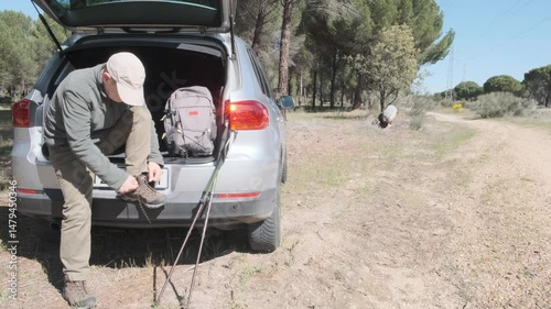 Man Preparing for a Day Hiking Adventure in a Scenic Forest Setting