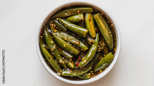 Spicy green chilly pickle in oil isolated on white background 