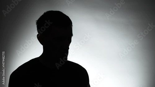 Anonymous interview with a man in a dark studio. Male silhouette.