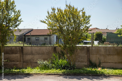 Concrete wall protecting private property in rural neighborhood