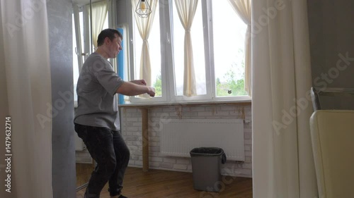 A man throws trash paper into a trash can. Rejoice at hitting the target. The man is a champion and winner of the emotion of joy. Slow motion.
