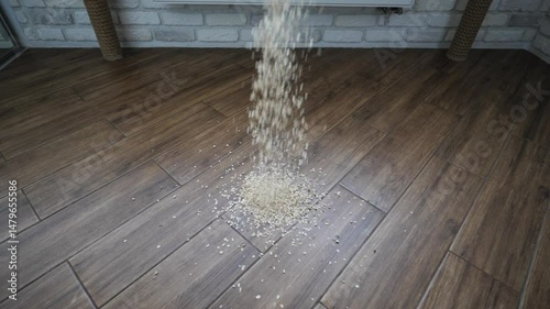 Oatmeal spills onto the floor in slow motion. Trash falls to the floor.
