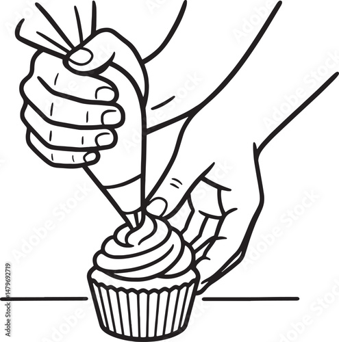 Hand using a piping bag to frost a cupcake