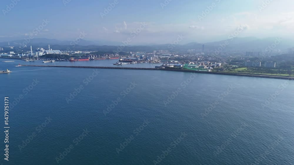 Coastal drone view of Donghae city harbor and urban skyline in Gangwon Province, South Korea Coastal drone view of Donghae city harbor and urban skyline in Gangwon Province, South Korea