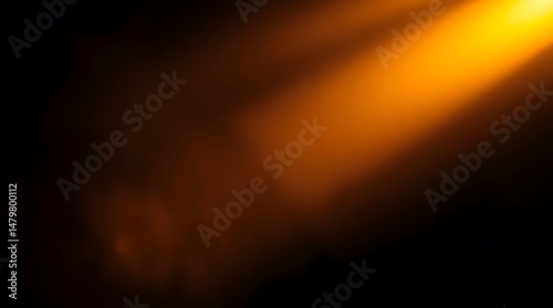 Abstract Orange Light Beam Against Black Dark Background. Warm orange light beam illuminating softly against a textured dark black background. Creating a warm and dramatic mood.
