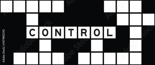 Alphabet letter in word control on crossword puzzle background