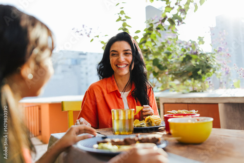 Mother and daughter enjoying a joyful meal together outdoors