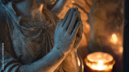 Angel statue praying hands with candle light memorial sculpture and religious symbol art