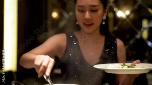 Asian adult preparing and enjoy traditional Chim chum thai hotpot spice meal dinner in luxury restaurant