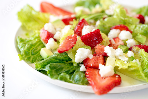 Salad with strawberries, avocado and goat cheese.