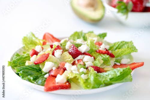Salad with strawberries, avocado and goat cheese.