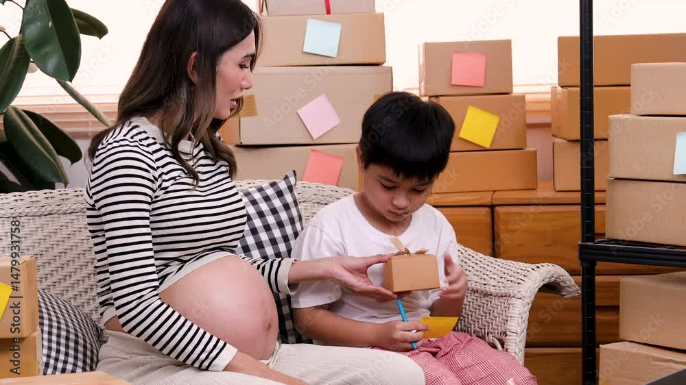 Children daughter and son help pregnant mother pack products or check orders after selling online by making a video or live streaming, digital marketing freelance small business owner working concept