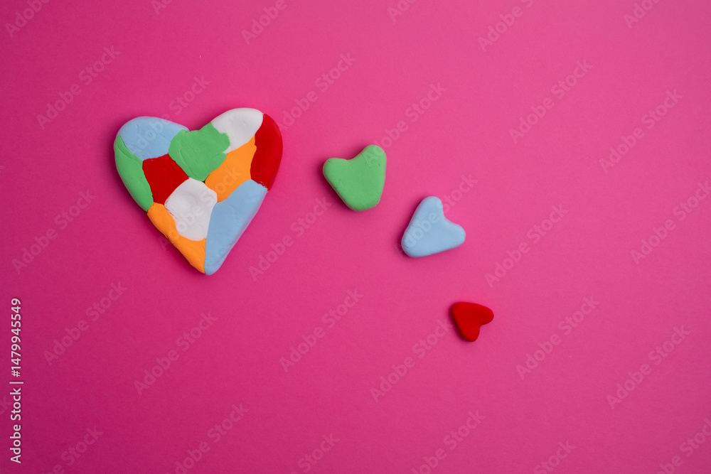 Obraz premium Autism awareness day, world autism day. Colored heart on color background