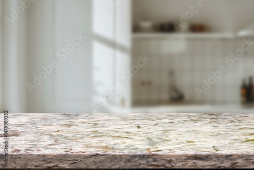 Empty wooden kitchen counter mockup, product display background. Wood table top on marble, blurred interior. Modern style home kitchen, restaurant advertising. Copy space for food, drinks, dishes