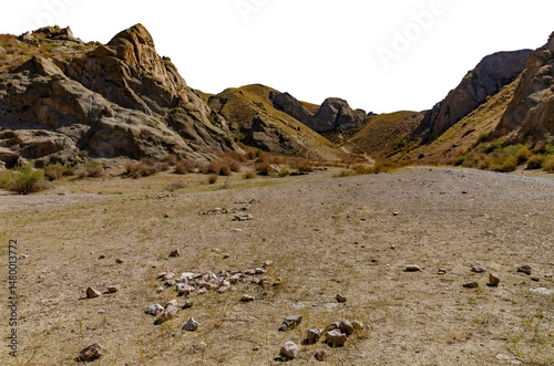 Arid Rocky Mountain Landscape with Dry Slopes, Boulders, and Vegetation under Harsh Sunlight in Remote Region. cut out object with transparent background