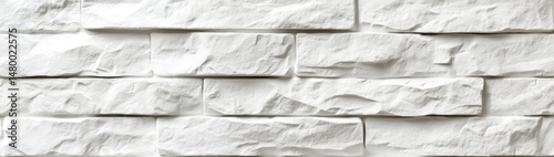 White stone-like wall texture.  Close-up view of rectangular,  textured white stonework, resembling natural brickwork,  with subtle variations in tone and surface detail