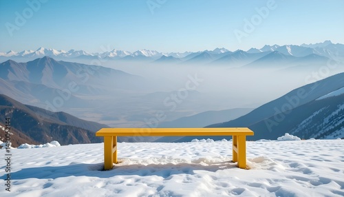 Breathtaking View of Snow-Capped Mountains with a Vibrant Yellow Bench in the Foreground Against a Clear Blue Sky.