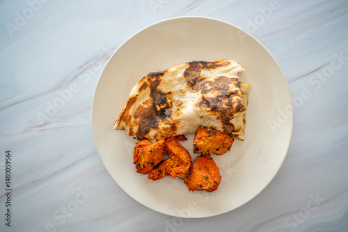 Spicy Chicken Tikka served butter naan bread