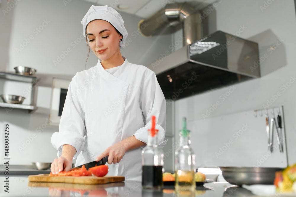 cooking and food concept - smiling female chef, cook chopping vegetables cooking and food concept - smiling female chef, cook chopping vegetables