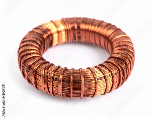Copper wire toroid showing tight, layered windings on a white background