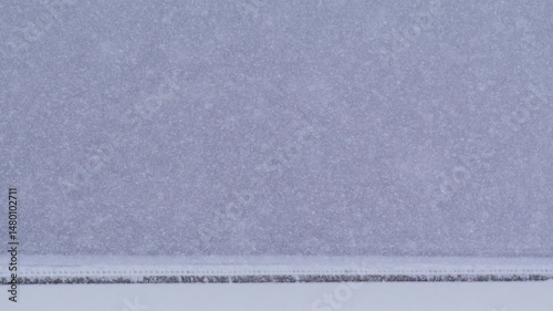 Snow falling in holiday season macro and slow motion.