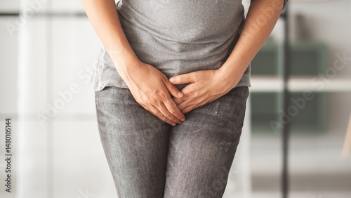 Fotografija Woman holding her groin in home