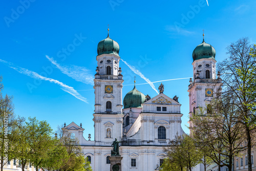 St. Stephans cathedral in Passau, Germany is an old white church with green metal domes on top of the towers